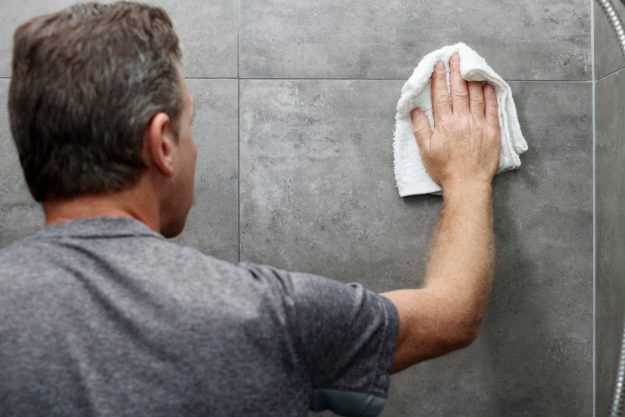 Male,Scrubbing,A,Home,Bathroom,Gray,Tile,Shower,Wall,With Spring cleaning your bathroom